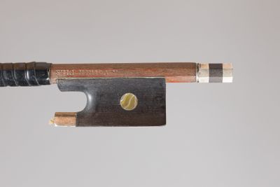 a close up of a violin bow with a wooden handle