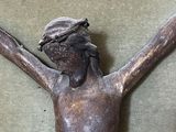 a statue of jesus on the cross on the floor