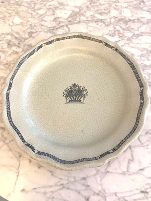 a plate with a crown on it sitting on a table