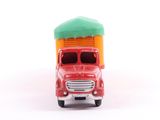 a red toy truck with a green roof and a green roof