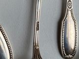 five spoons and two spoon spoons on a table