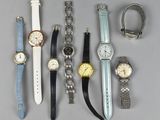 a lot of watches that are sitting on a table