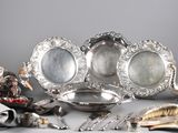 a silver plate with a lot of silver items on it
