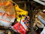 a pile of assorted items on a shelf in a garage