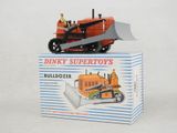 a toy tractor with a man on top of it in a box