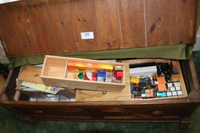 a wooden box filled with assorted items on top of a table