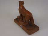 an image of a statue of a cat on a wooden base