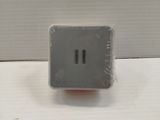 a small gray electrical outlet on a white wall