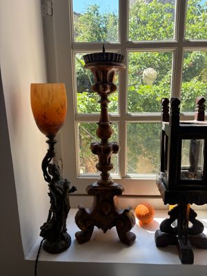 a lamp that is sitting on a window sill next to a lamp