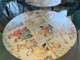 many tables with comic comics on them in a room