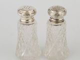 a pair of cut glass salt and pepper shakers