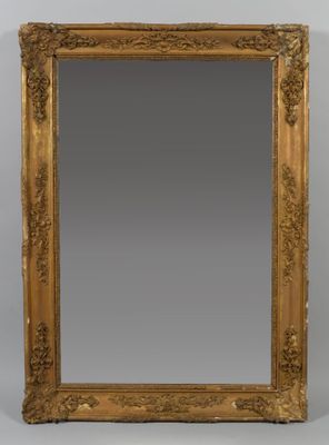 a gold framed mirror with a decorative design on the edge
