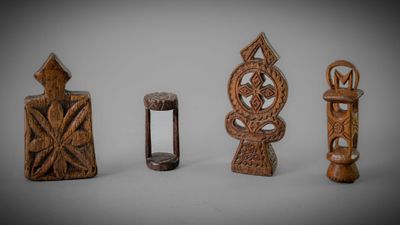 several pieces of carved wood sitting on top of a white surface