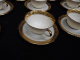 a lot of cups and saucers sitting on a table