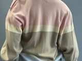an image of a mannequin mannequin wearing a pink and beige sweater