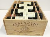 bottles of red wine in a wooden box on a table