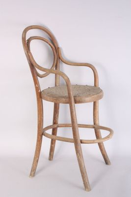 an image of a wooden chair with a woven seat on a white background