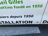 a sign on the side of a white car that says sell gills