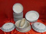 a lot of plates and bowls on the table
