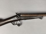 an old gun that is on display on a table