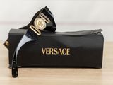 versa versa sunglasses in a black case on a wooden table