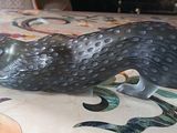 a figurine of a bird on a table