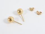 three pairs of gold stud earrings on a white surface
