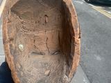 a person holding a piece of wood in their hand