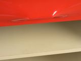 a close up of a red object on a shelf