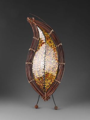 a close up of a sculpture of a leaf on a stand