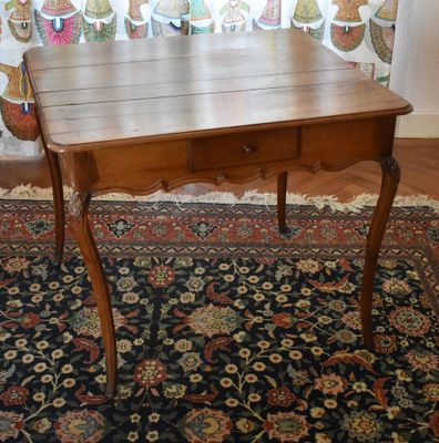 a small wooden table with a drawer on top of it