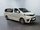 the white van is parked in a large room with a black floor
