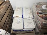 a pile of mattresses sitting on a pallet in a room