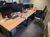 an image of an office cubicle with multiple computers