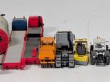 a lot of toy trucks that are lined up on a table