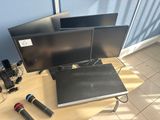 two monitors and a microphone sitting on a table