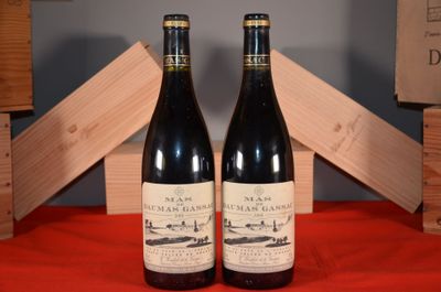 two bottles of wine sitting next to each other on a table
