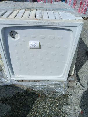 a white microwave sitting on a pallet in a lot