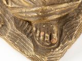 gold statue of a person wrapped up in a scarf