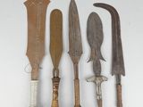 several different types of knives are lined up on a white surface