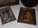 two framed pictures of a child and a dog are on a table