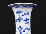 a blue and white vase sitting on top of a table