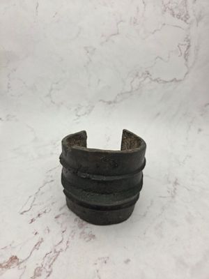 a close up of a black ring on a marble surface