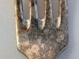 a fork that has some dirt on it