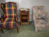 a chair and a chair with a plaid cover in a room