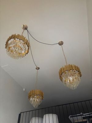 three chandeliers hanging from the ceiling in a room