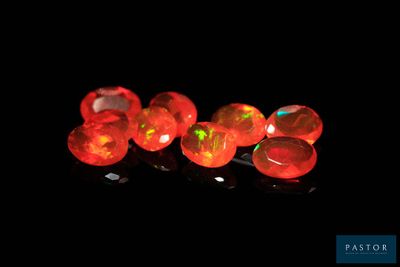 several red fire oplite beads are lit up in the dark