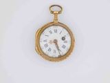 a gold pocket watch with roman numerals on the face
