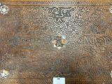 a wooden box with a decorative design on it