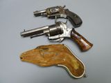 two revolvers are sitting next to each other on a table
